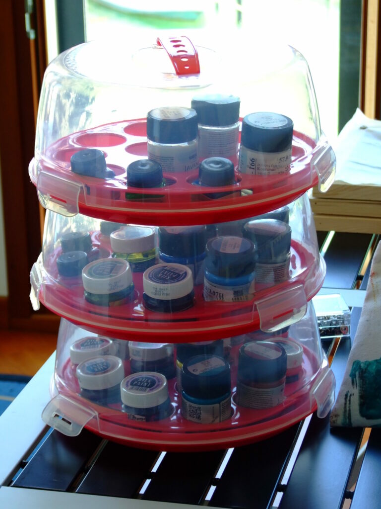 stack of muffin carriers holding paint pots