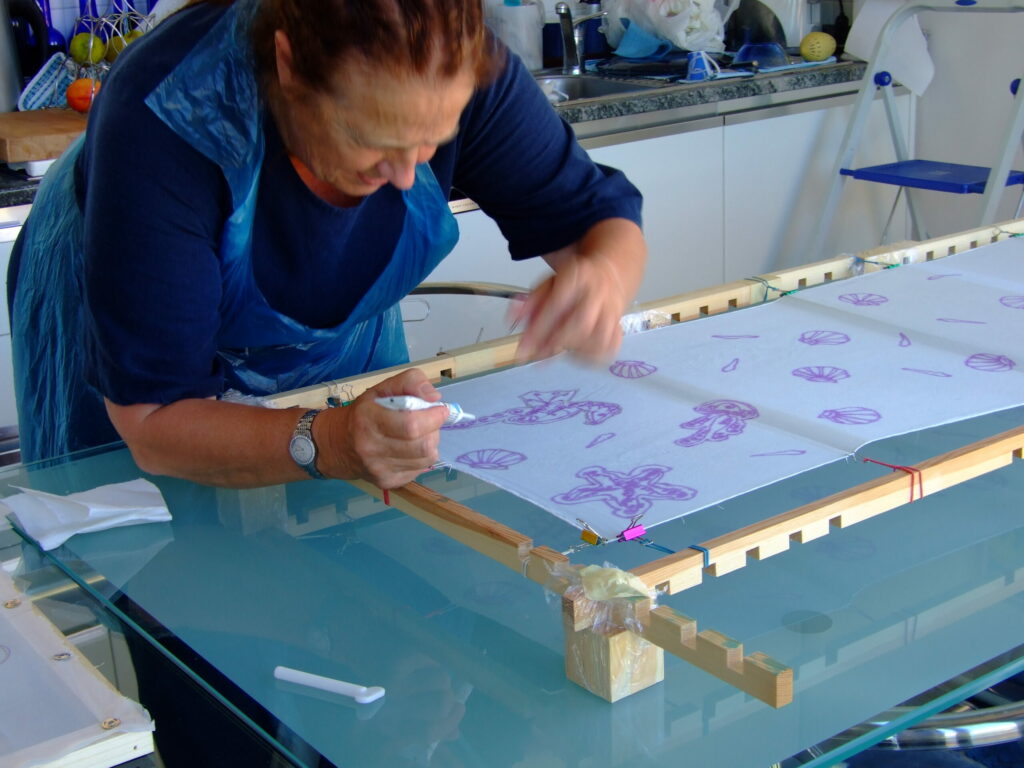 woman painting silk scarf